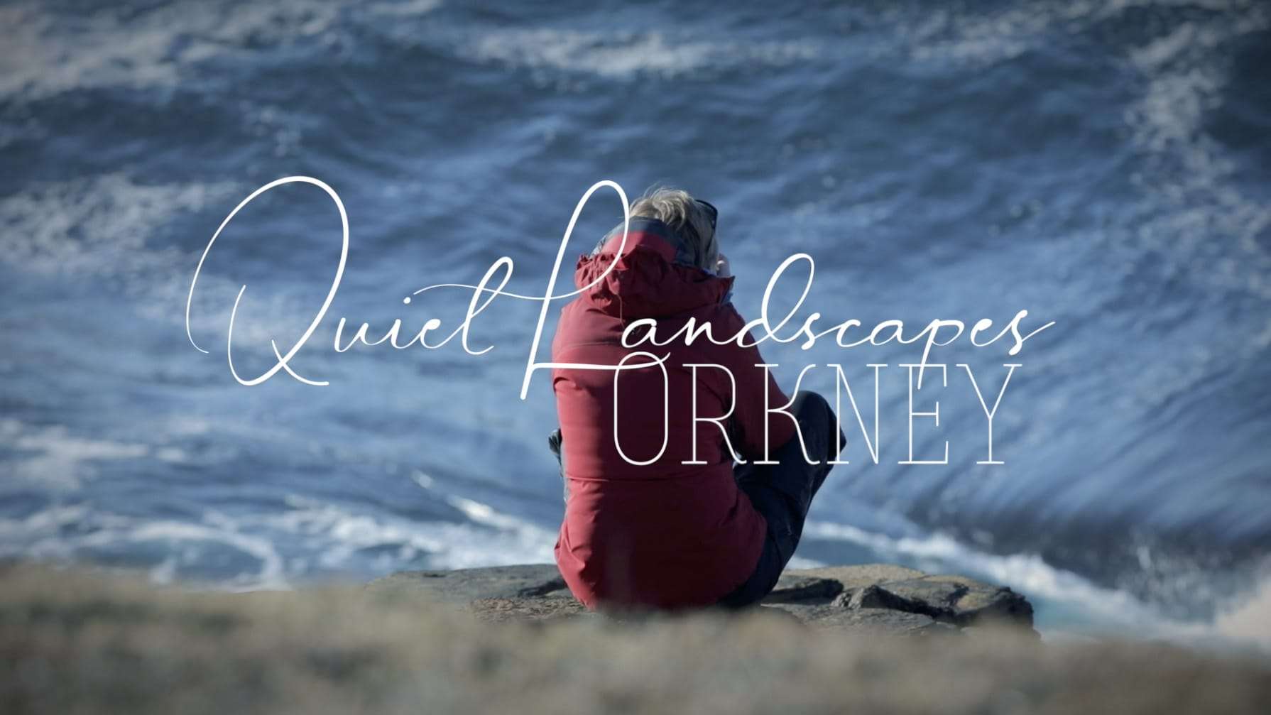 Person sitting on a rock overlooking waves with text "Quiet Landscapes ORKNEY" overlayed.