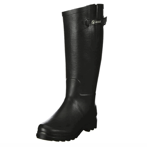A single black leather riding boot with buckle detail against a white background.