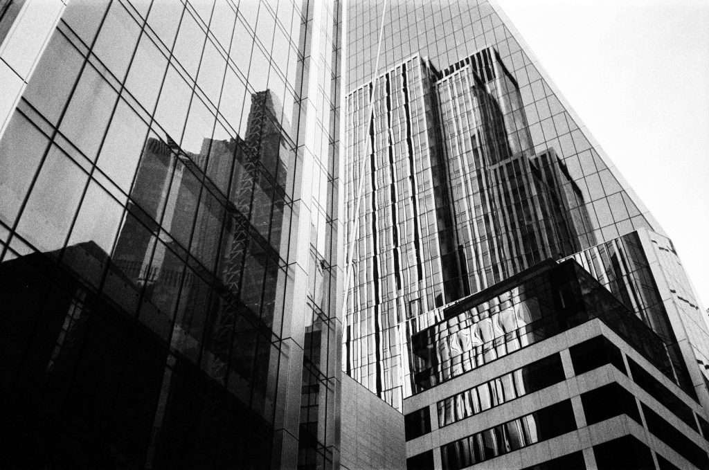 Black and white photo of modern skyscrapers with reflective glass facades