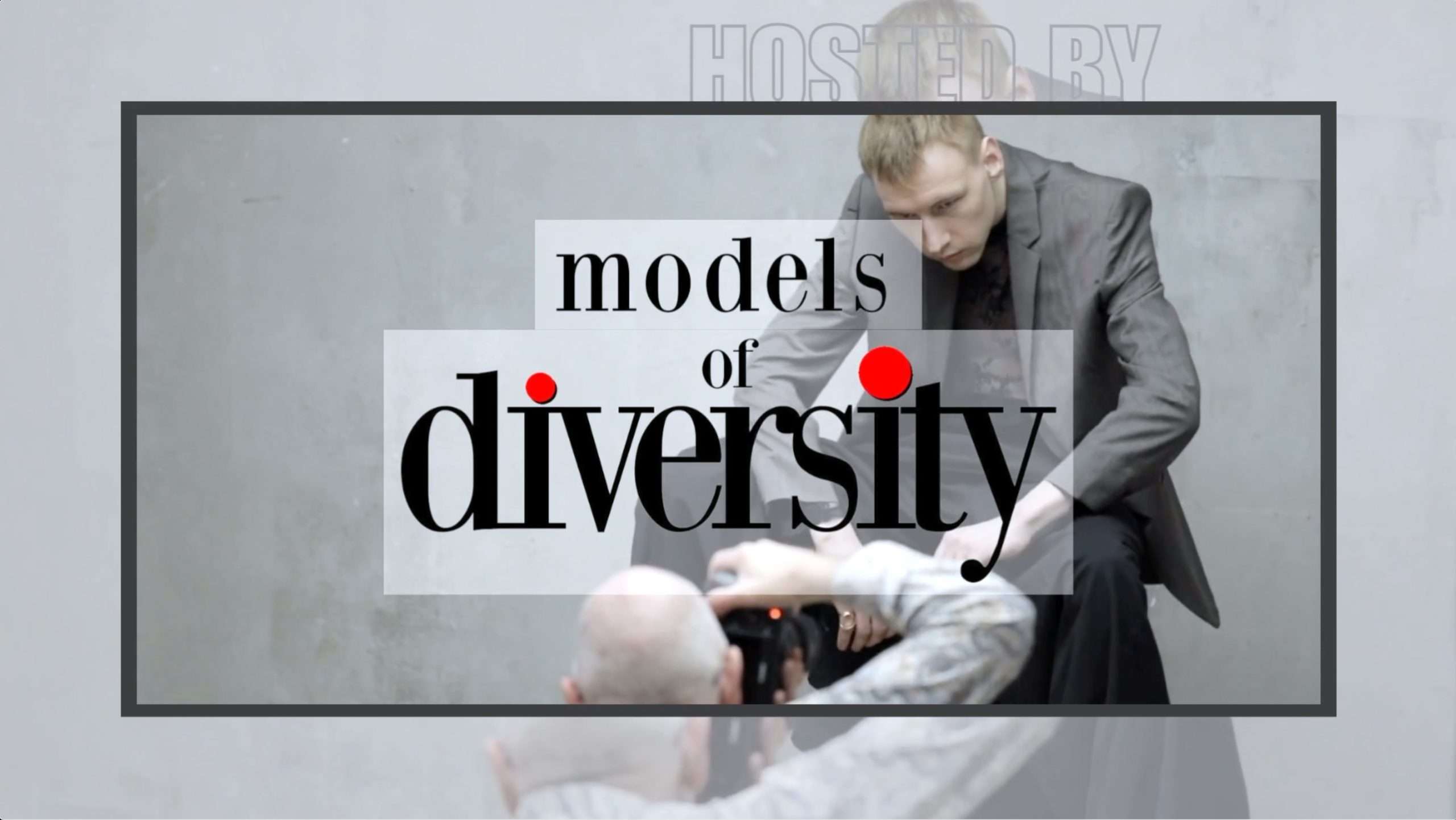 A photo of a promotional graphic for a "Models of Diversity" event with a male model seated and being photographed in the background.