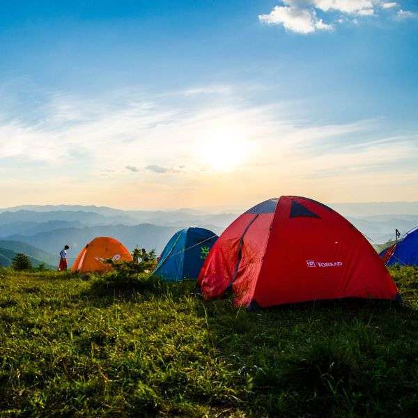 tents in a row in the countryside on a sunny day.