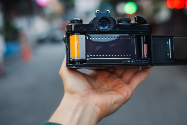 Opening the back of a film camera with film loaded