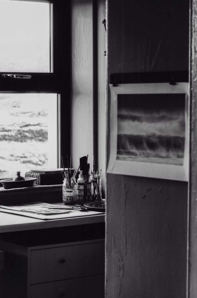 art tools in a room with a print on the wall.