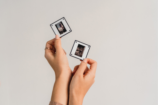 hands holding two slide photography negatives