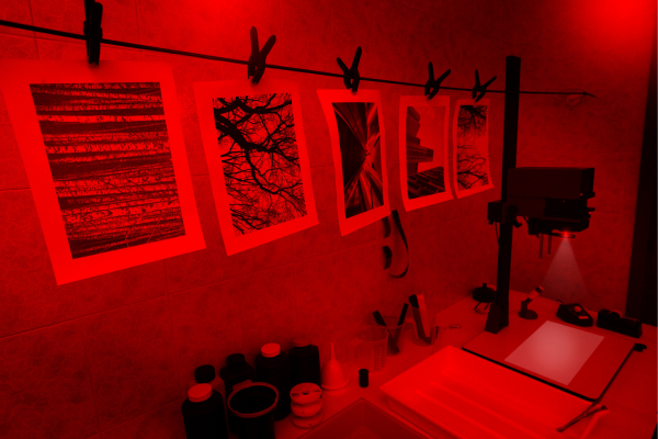 view of a darkroom with prints hanging on a line